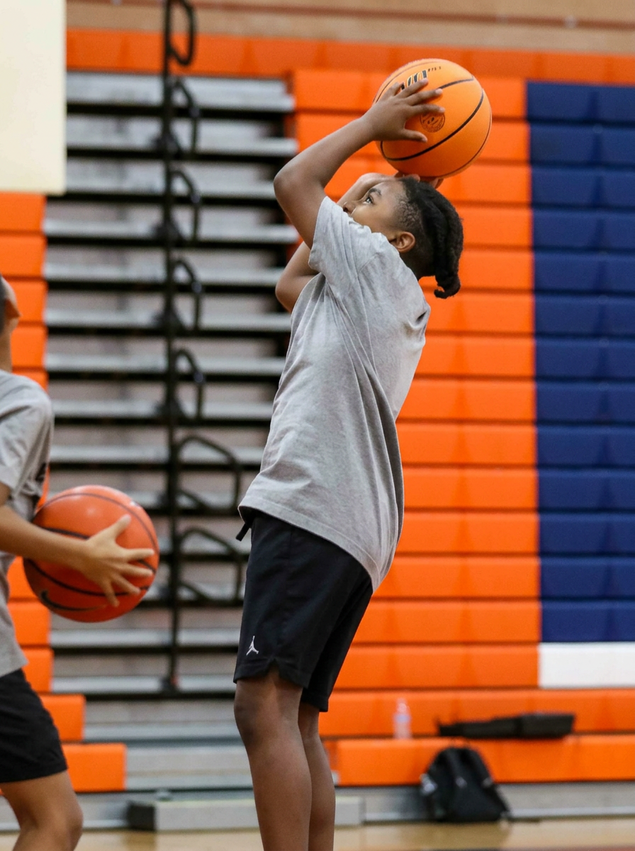 Youth basketball player driving to the hoop during morning training